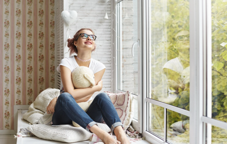 happy woman relaxing in a beautifully designed backyard with comfortable outdoor living space