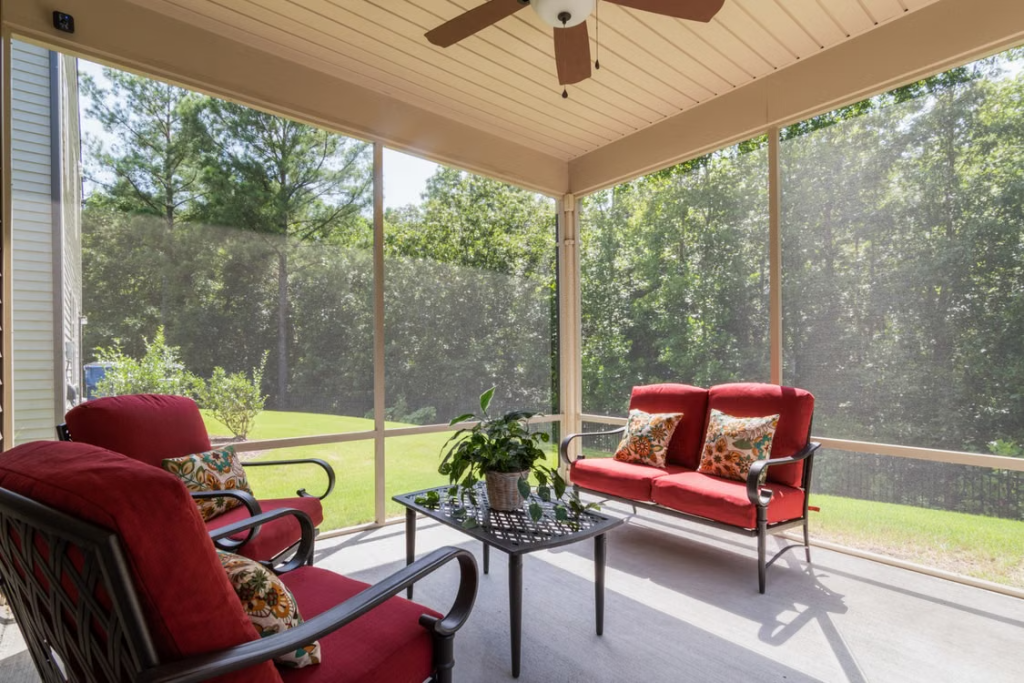 screened porch with cozy seating creating a comfortable bug-free outdoor living area