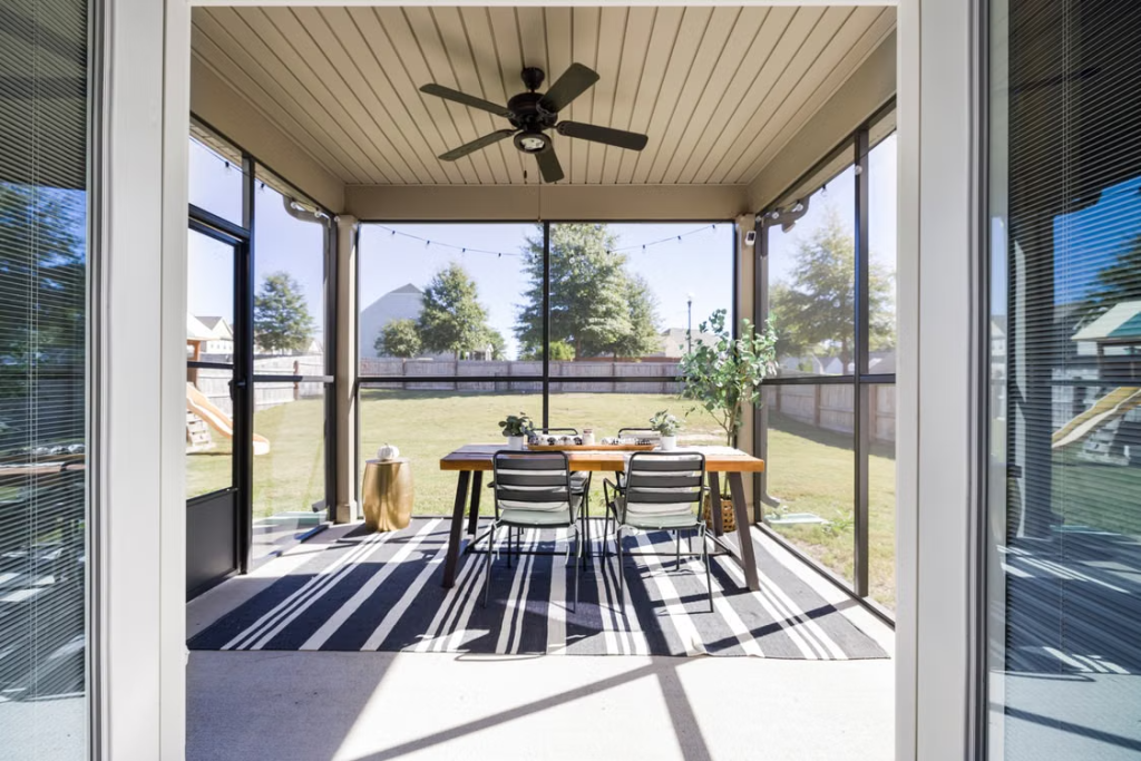 modern screened porch with comfortable seating and warm evening lighting