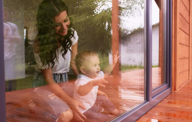 woman and child playing in a comfortable screened porch overlooking the backyard