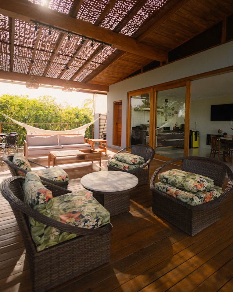 Covered patio transitioning from late afternoon into evening with comfortable seating and outdoor lighting